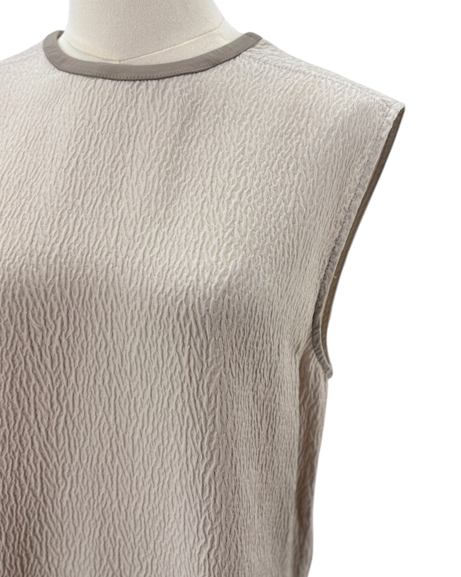 Helmut Lang beige sleeveless top on a mannequin with a white background
