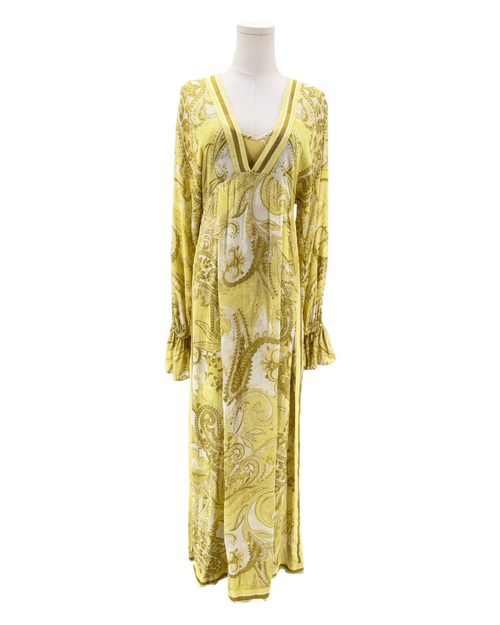 Yellow patterned dress on a mannequin against a white background