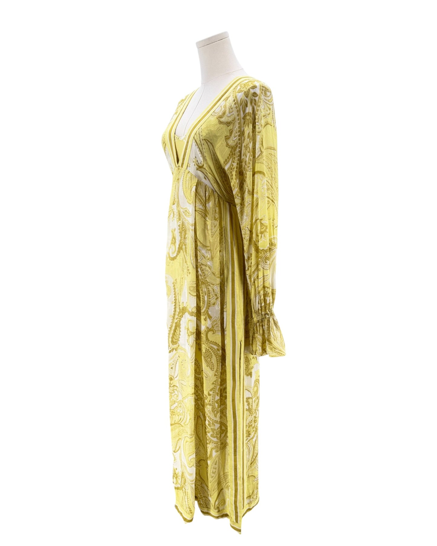Yellow floral dress on a mannequin against a white background