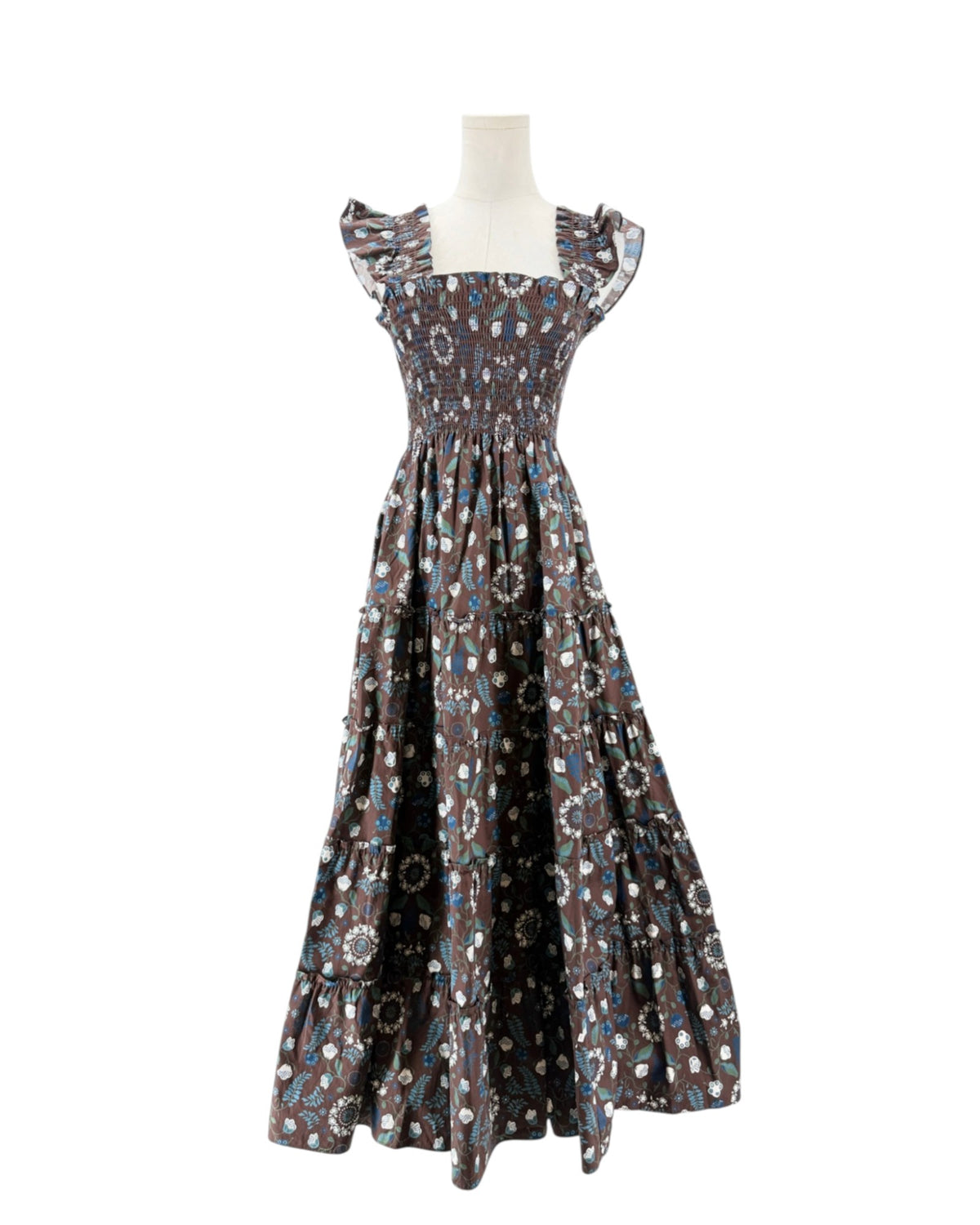 Brown and blue floral sleeveless maxi dress on a mannequin on a white background