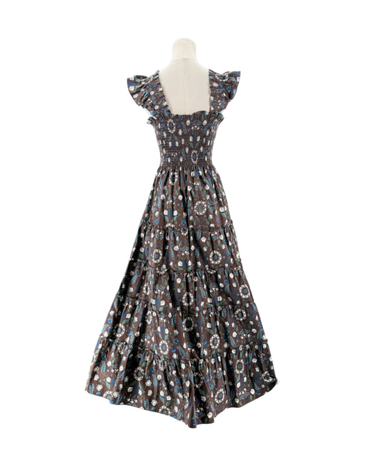 Brown and blue floral sleeveless maxi dress on a mannequin on a white background