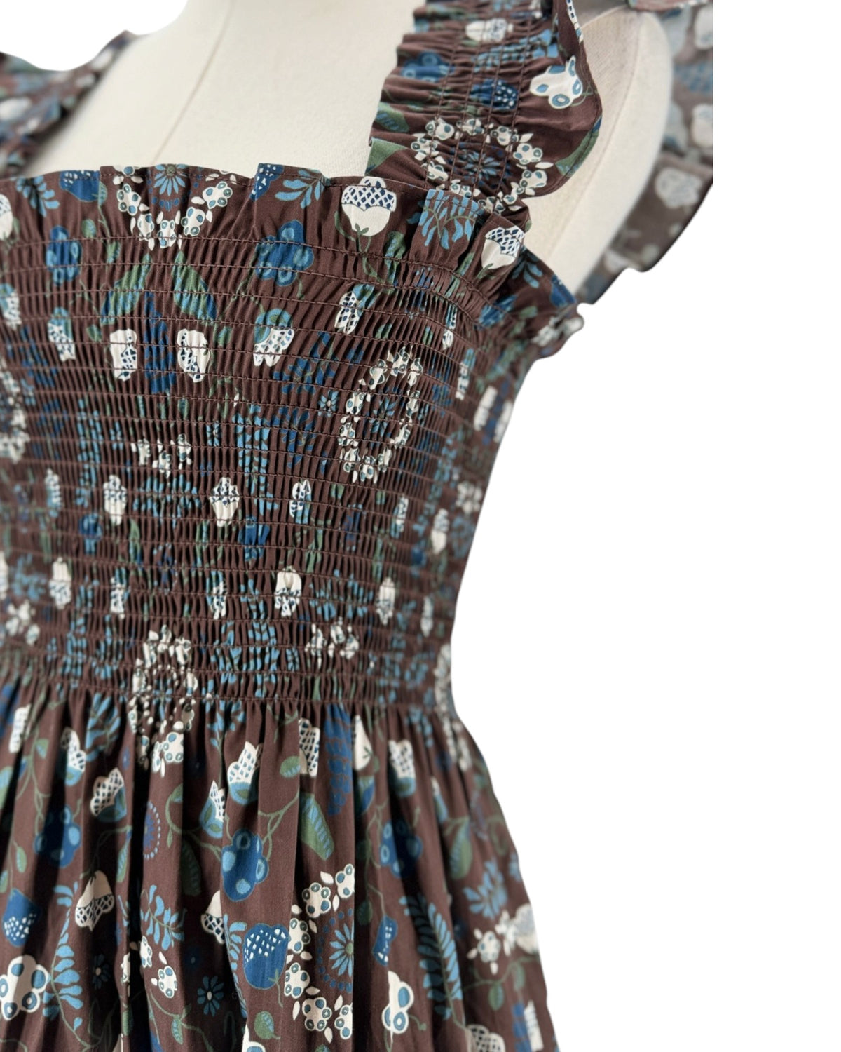 Brown and blue floral sleeveless maxi dress on a mannequin on a white background