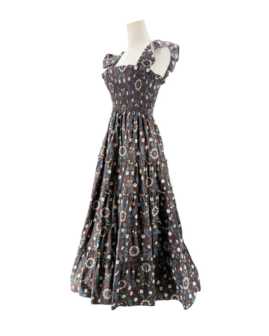 Brown and blue floral sleeveless maxi dress on a mannequin on a white background