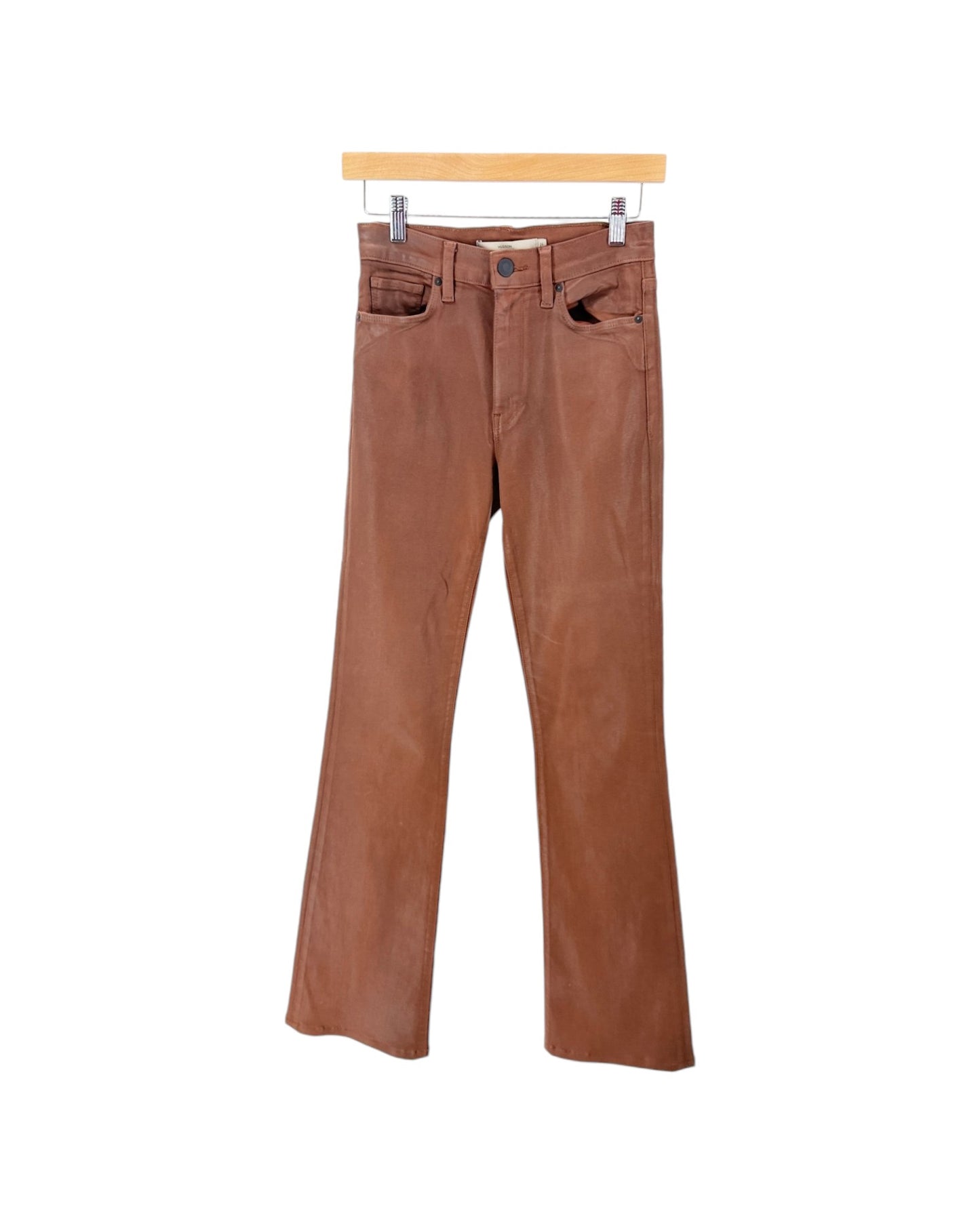 A pair of brown corduroy flare jeans hanging from a wooden hanger against a plain white background.