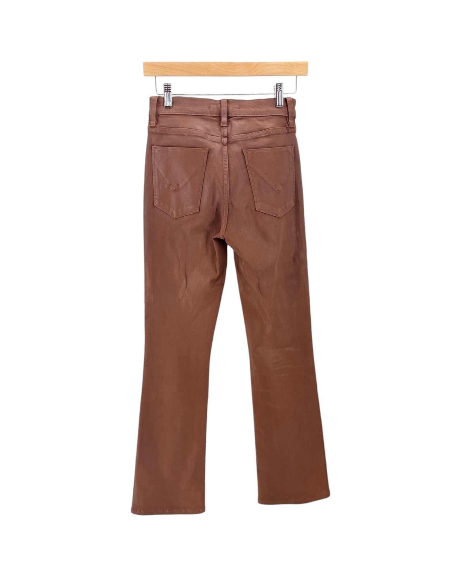A pair of brown straight-leg jeans shown from the back, hanging from a wooden hanger with metal clips against a plain white background.