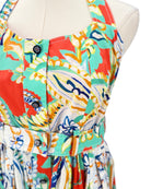 Colorful patterned dress on a mannequin against a white background