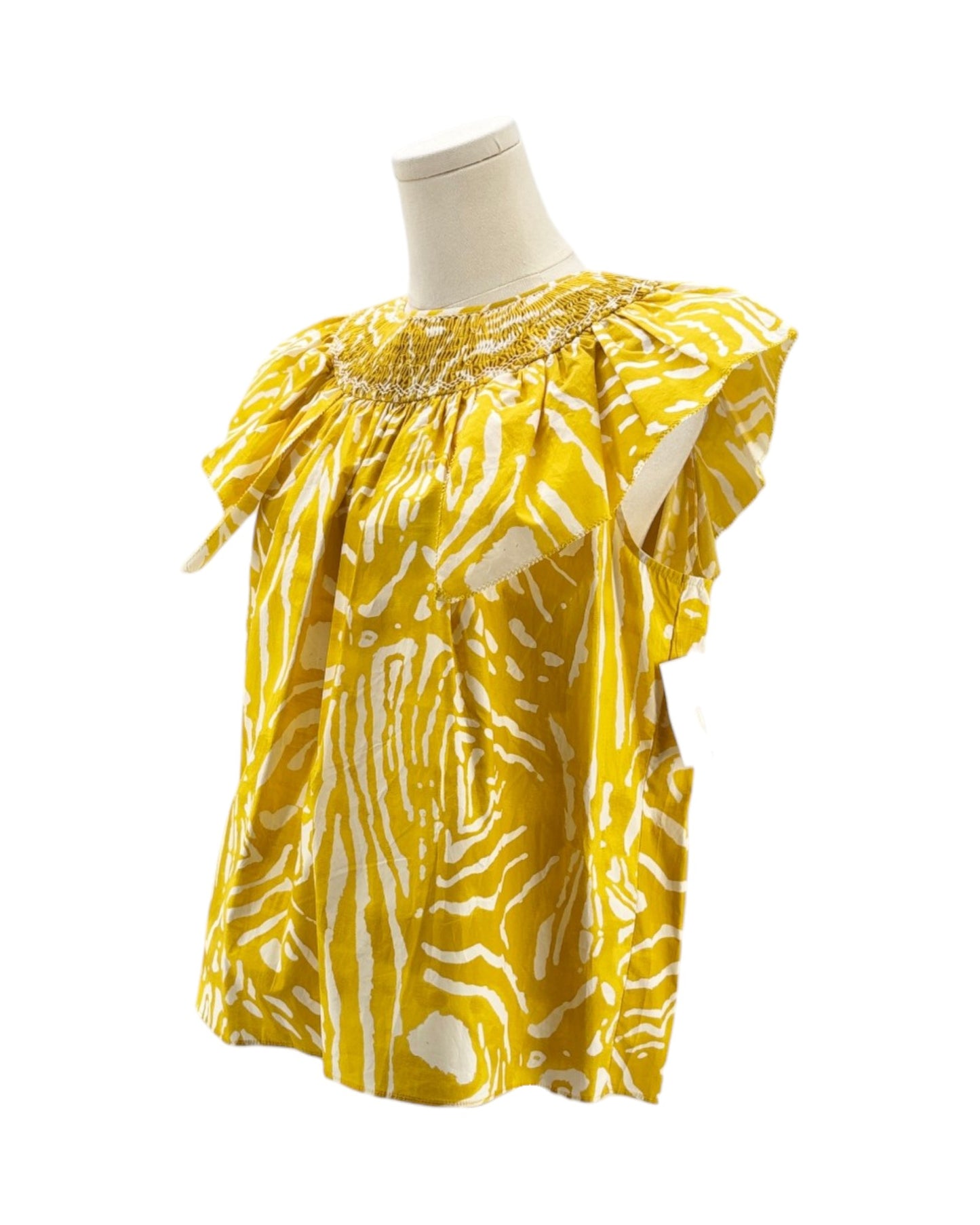 Yellow patterned blouse on a mannequin against a white background