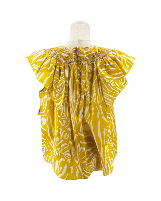 Yellow and white patterned baby romper on a mannequin against a white background