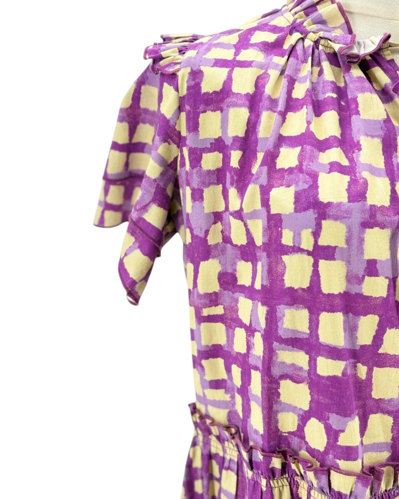 Purple and yellow checkered dress with a tie waist on a white background
