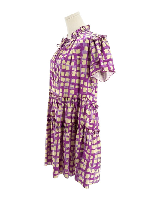 Purple and cream checkered dress on a mannequin against a white background