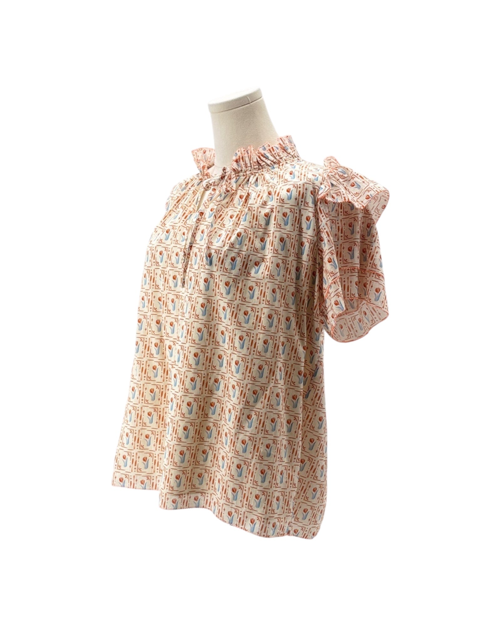 Floral patterned dress on a mannequin against a white background