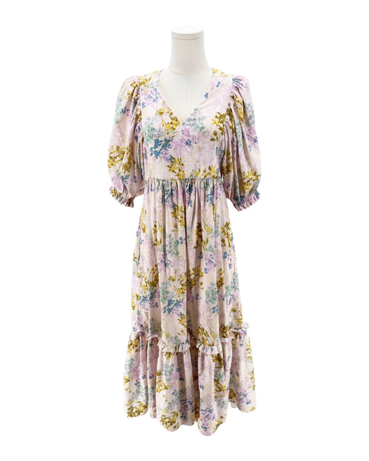 Floral dress on a mannequin against a white background