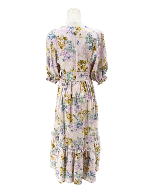 Floral dress on a mannequin against a white background
