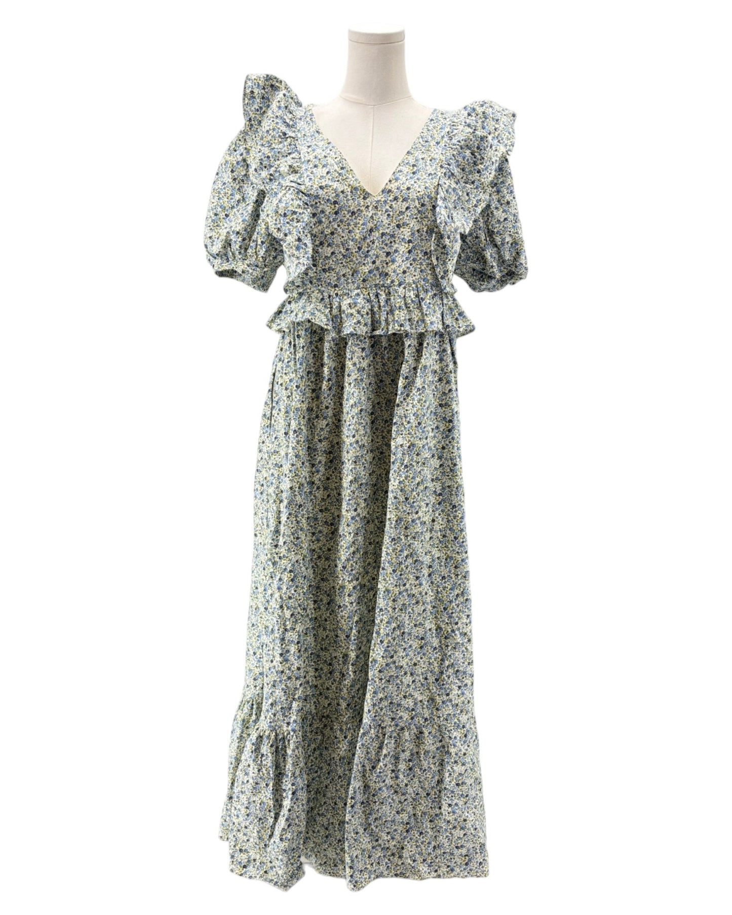 Floral dress on a mannequin against a white background