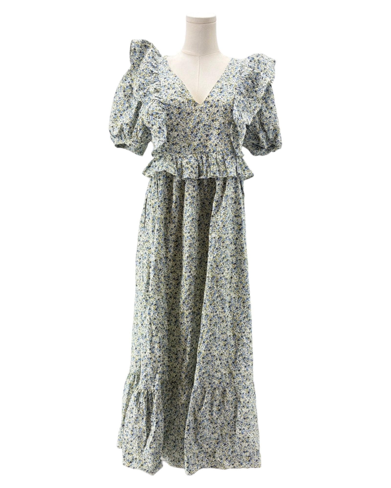 Floral dress on a mannequin against a white background