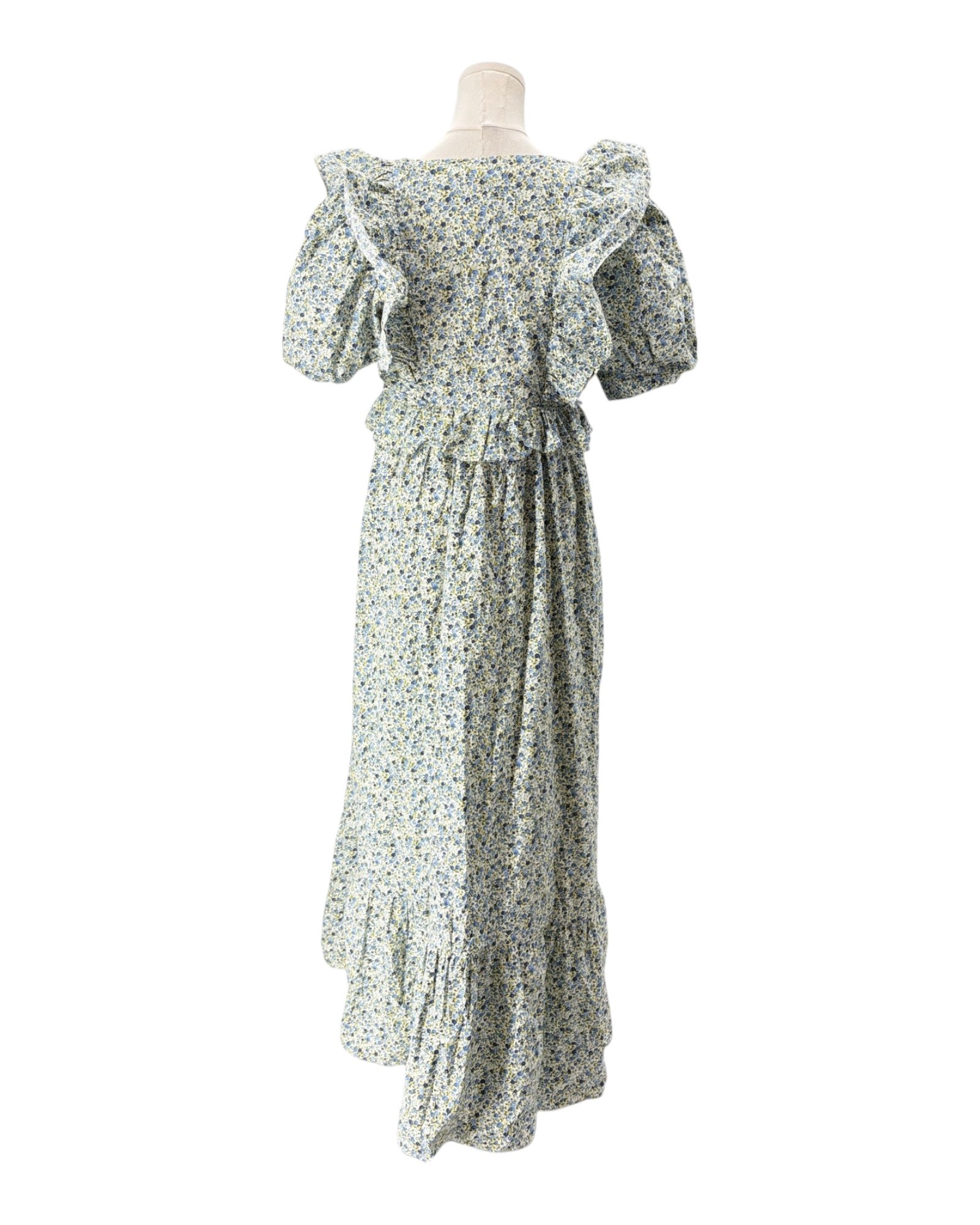 Floral dress on a mannequin against a white background