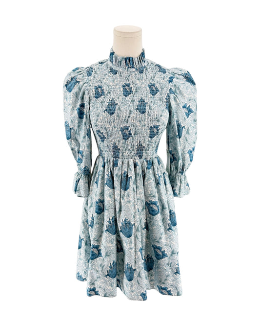 Blue floral mini dress with smocking on a mannequin on a white background