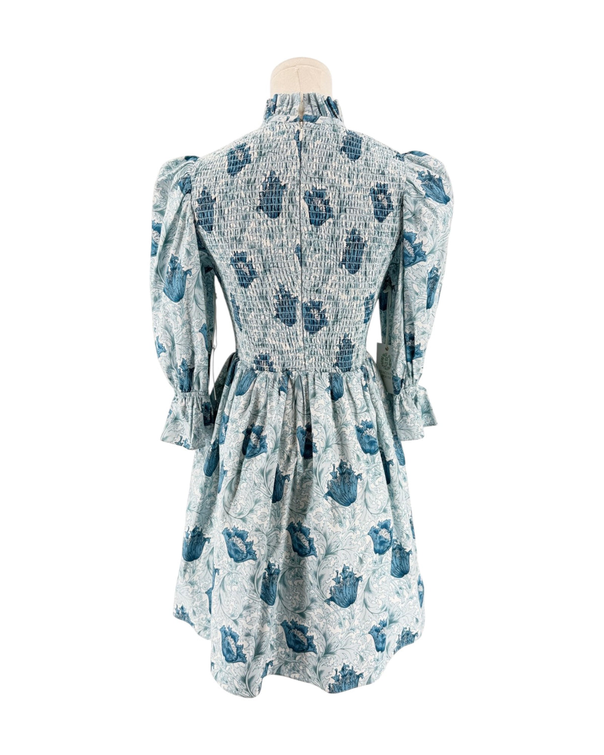 Blue floral mini dress with smocking on a mannequin on a white background