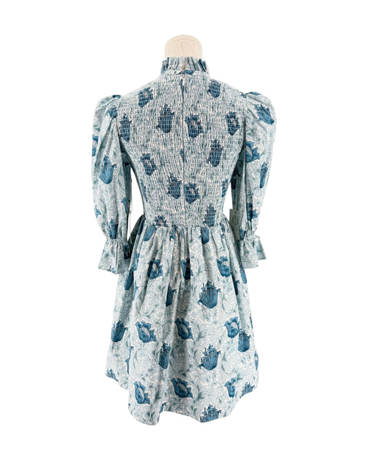 Blue floral mini dress with smocking on a mannequin on a white background