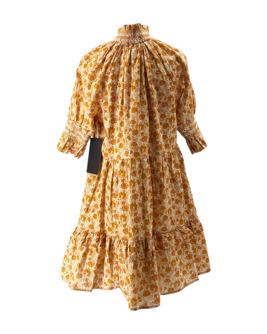 Yellow floral dress with a tag on a white background