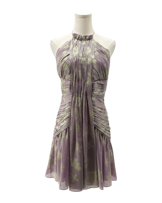 Purple and green patterned dress on a mannequin against a white background