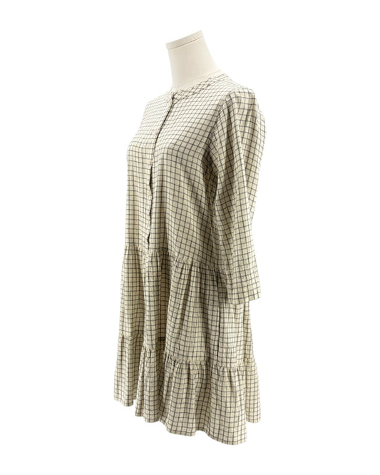 Checkered dress on a mannequin against a white background