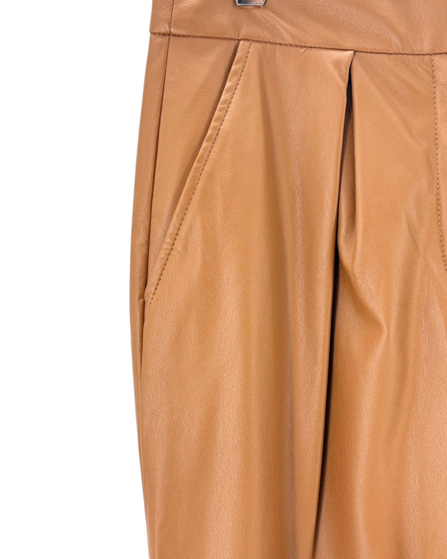 Close-up of tan pants with a white background