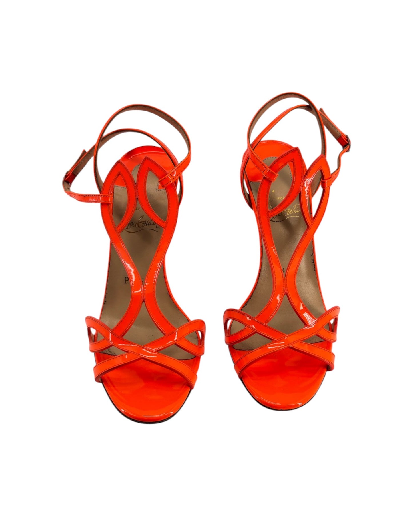 Pair of bright orange high-heeled sandals on a white background