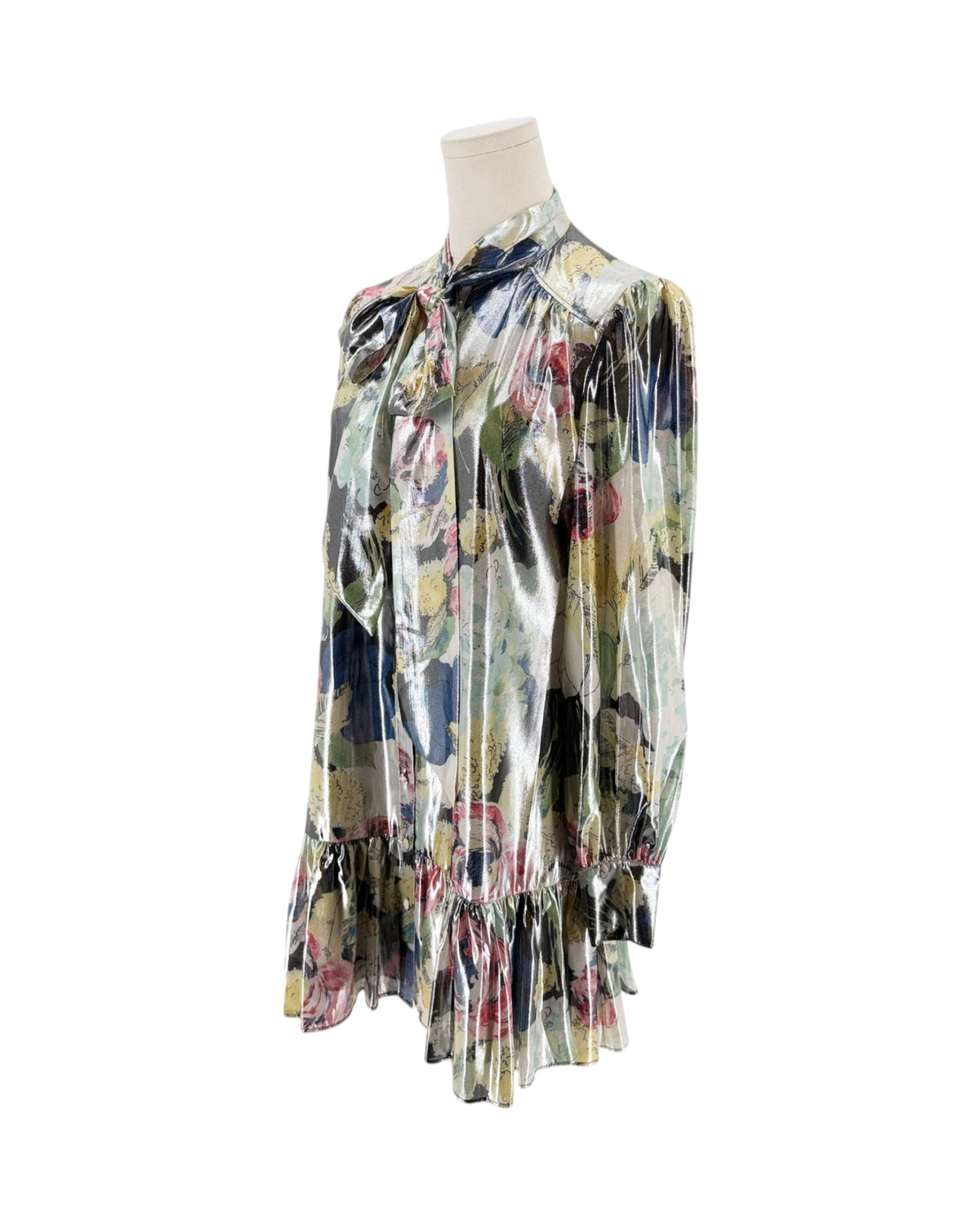 A long-sleeve satin blouse with a tie-neck bow and a multicolor floral print, displayed on a mannequin torso against a white background.