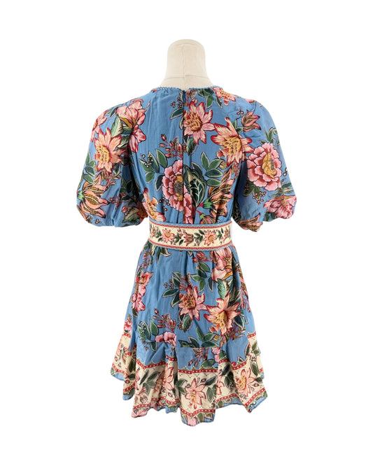 A blue floral print dress with puff sleeves and a matching waistband, displayed on a mannequin from the back against a white background.
