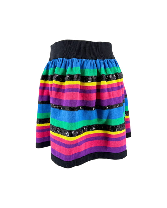 A colorful striped knit skirt with horizontal bands of blue, green, yellow, pink, purple, and black, accented with sequined black bands, shown against a plain white background.