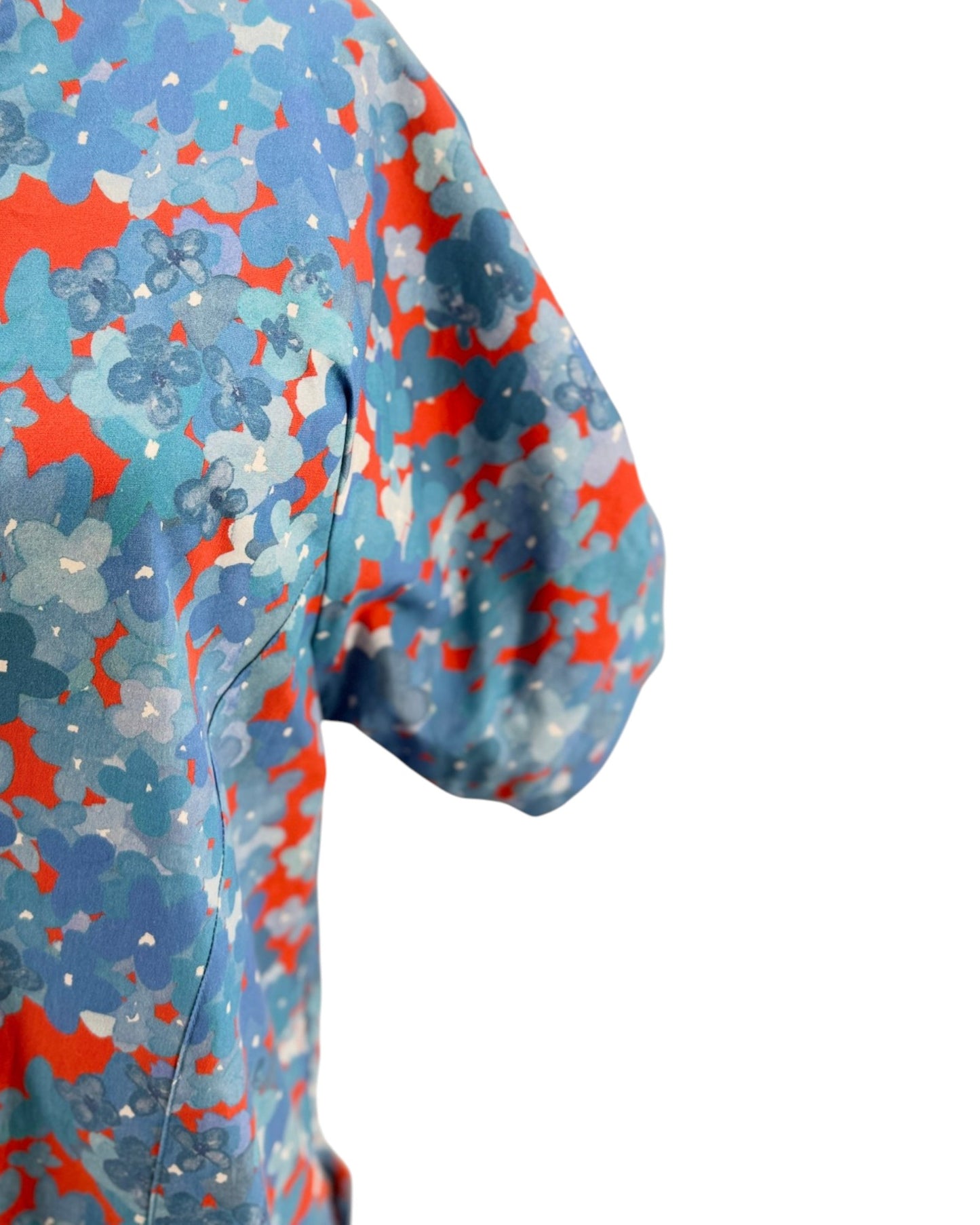 Close-up of a colorful patterned fabric with blue, red, and white colors on a white background.