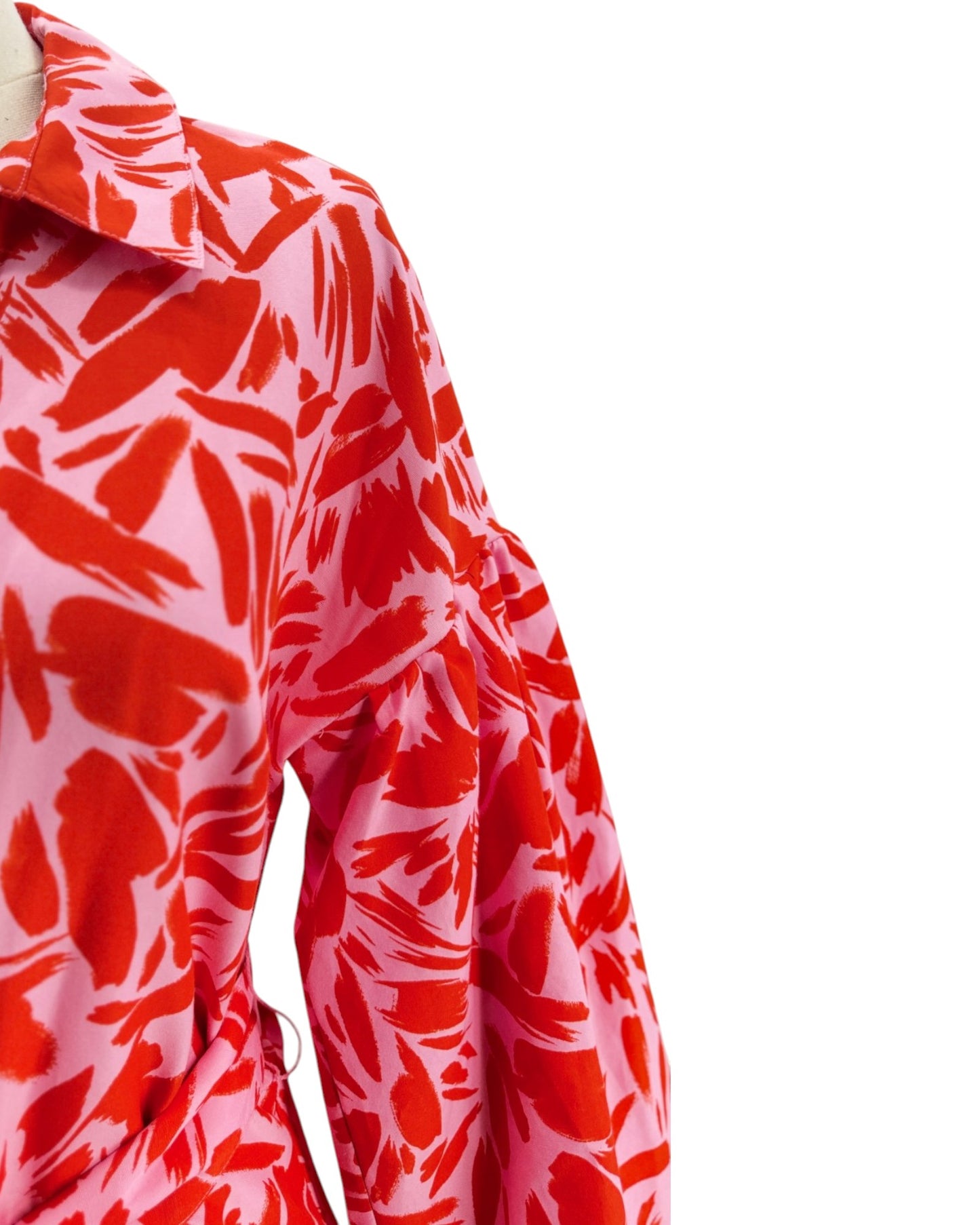 Red and pink floral patterned fabric on a white background