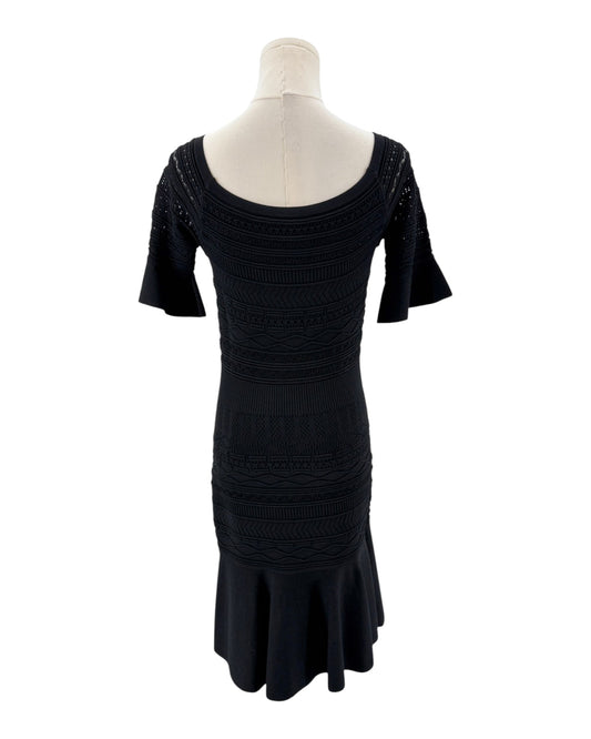 Black dress on a mannequin against a white background