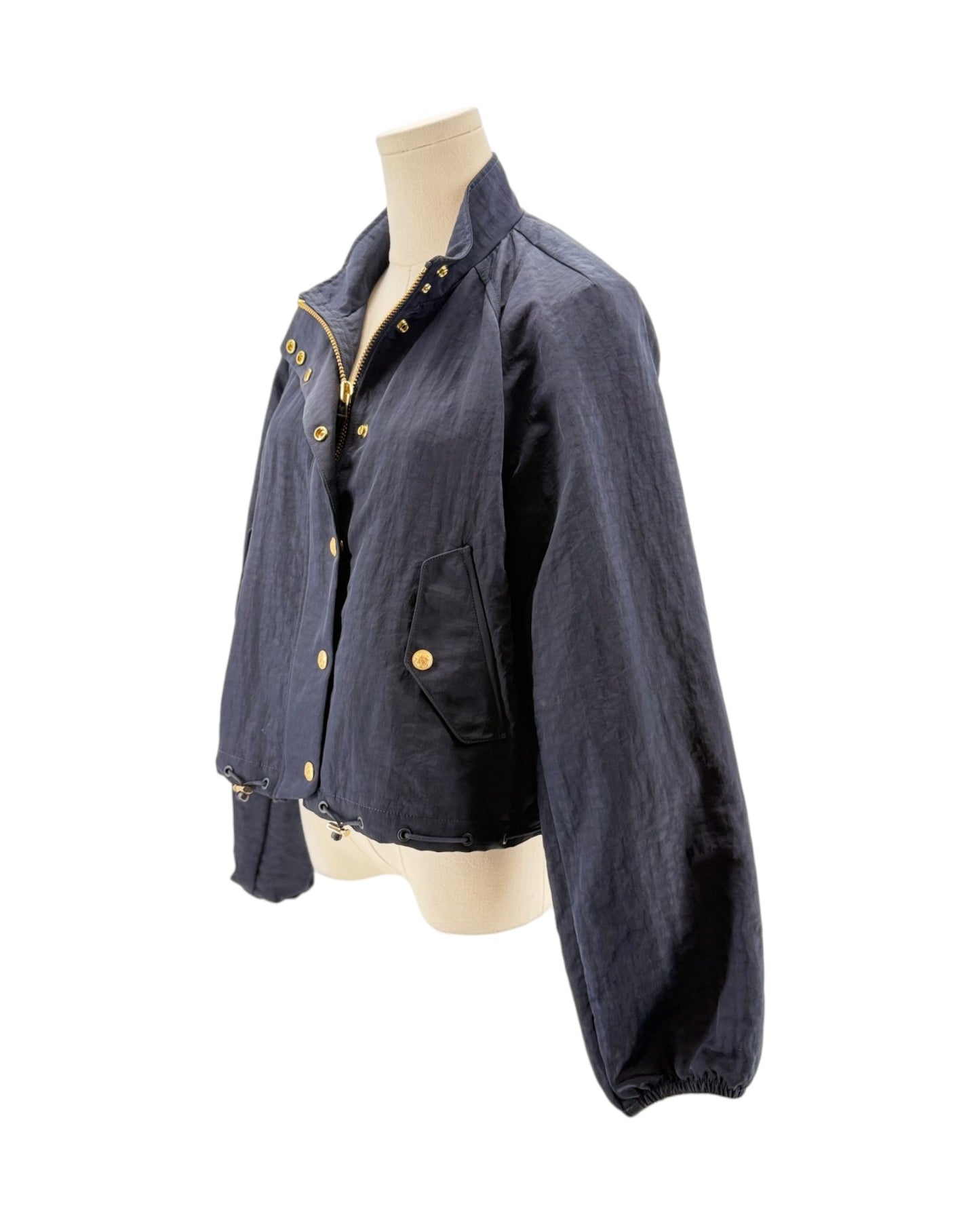 Navy jacket with gold buttons on a mannequin against a white background