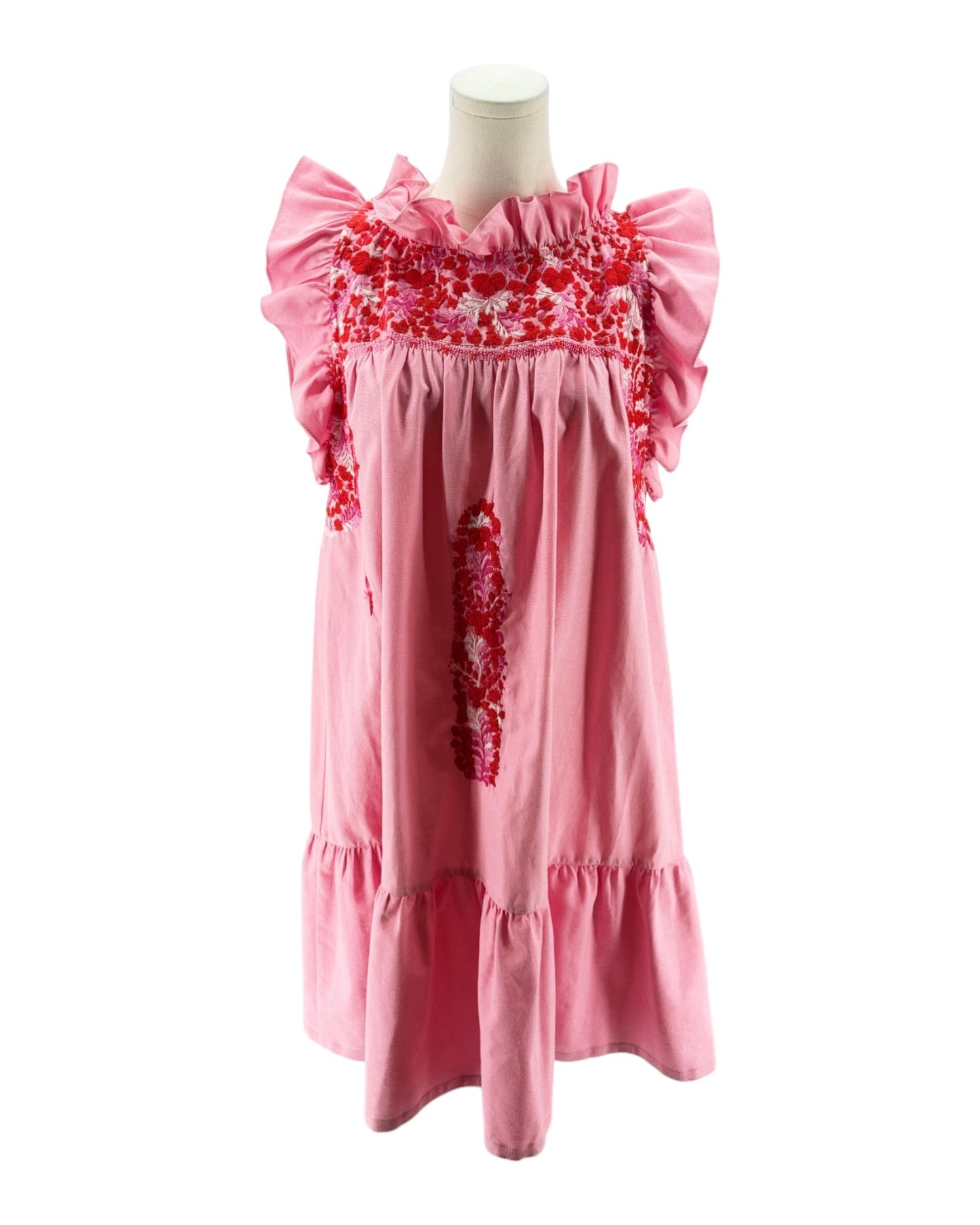 Pink dress with floral embroidery on a mannequin against a white background