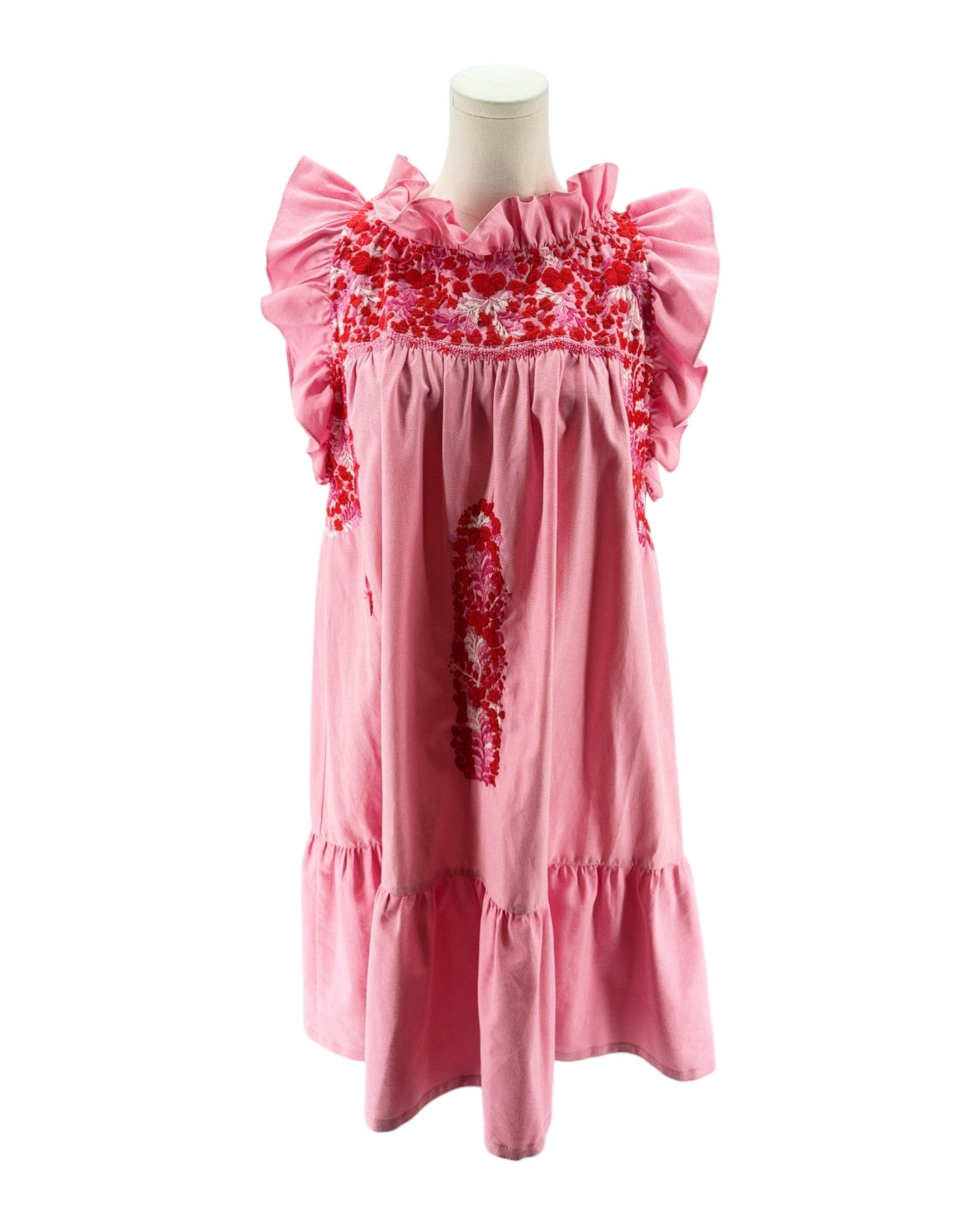 Pink dress with floral embroidery on a mannequin against a white background