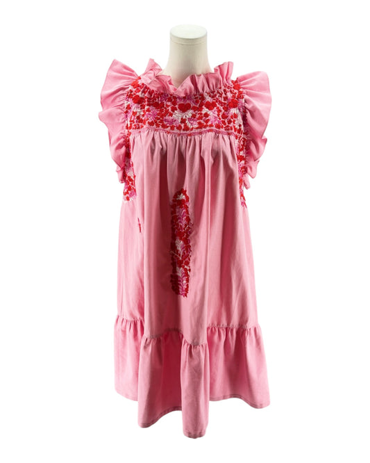 Pink dress with floral embroidery on a mannequin against a white background