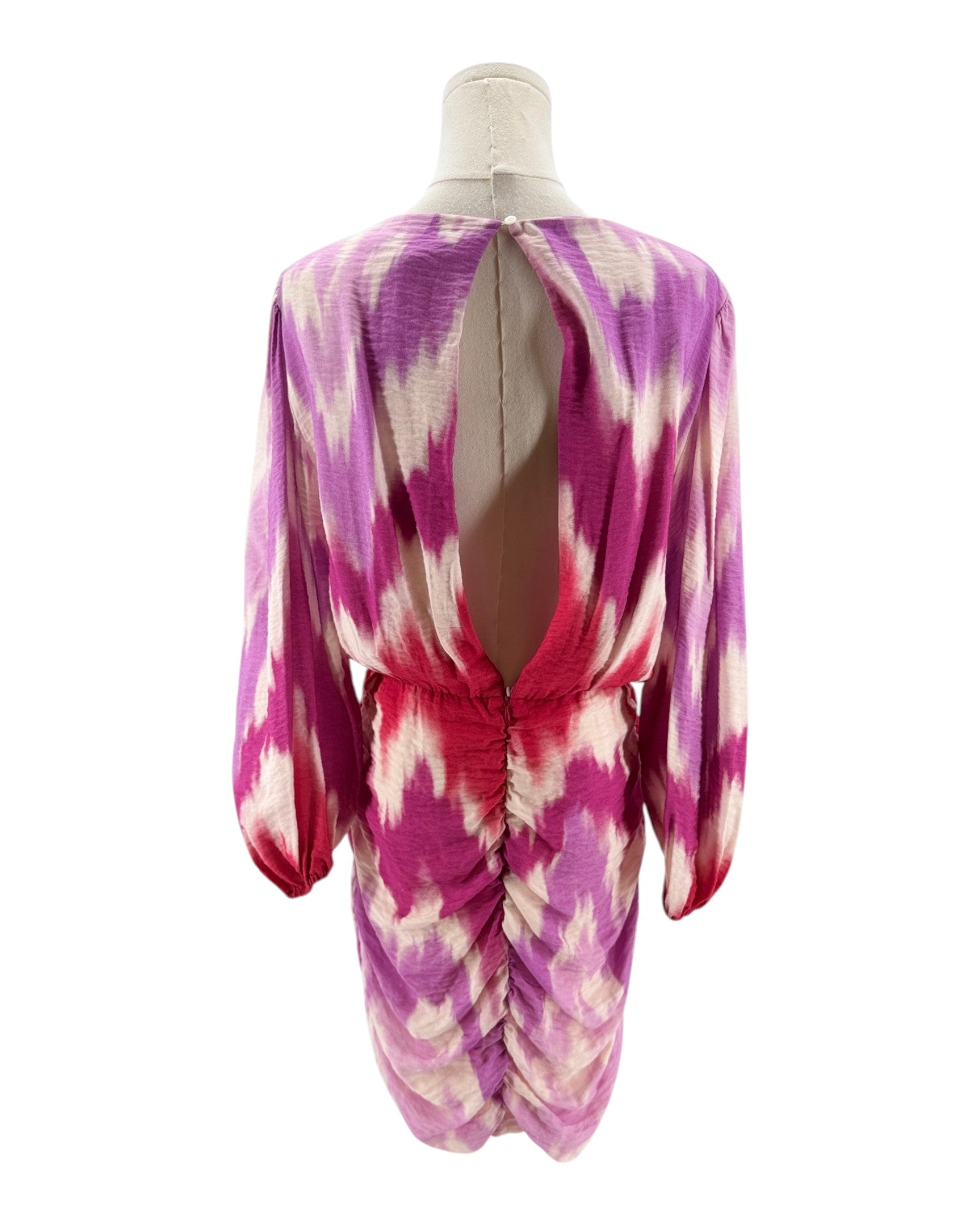 Mannequin wearing a pink and purple tie-dye dress on a white background