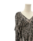 IRO sheer patterned blouse on a mannequin against a white background