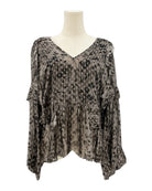 IRO sheer patterned blouse on a mannequin against a white background