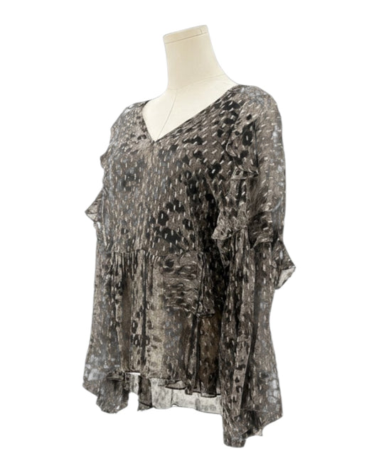 IRO sheer patterned blouse on a mannequin against a white background