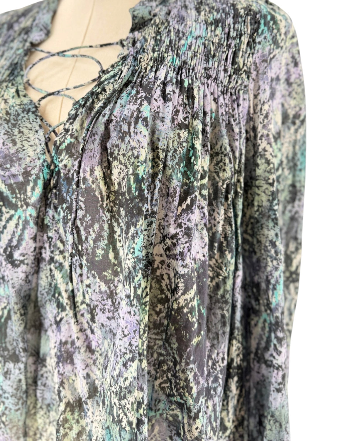 Long sleeve multicolor blouse on a mannequin on a white background