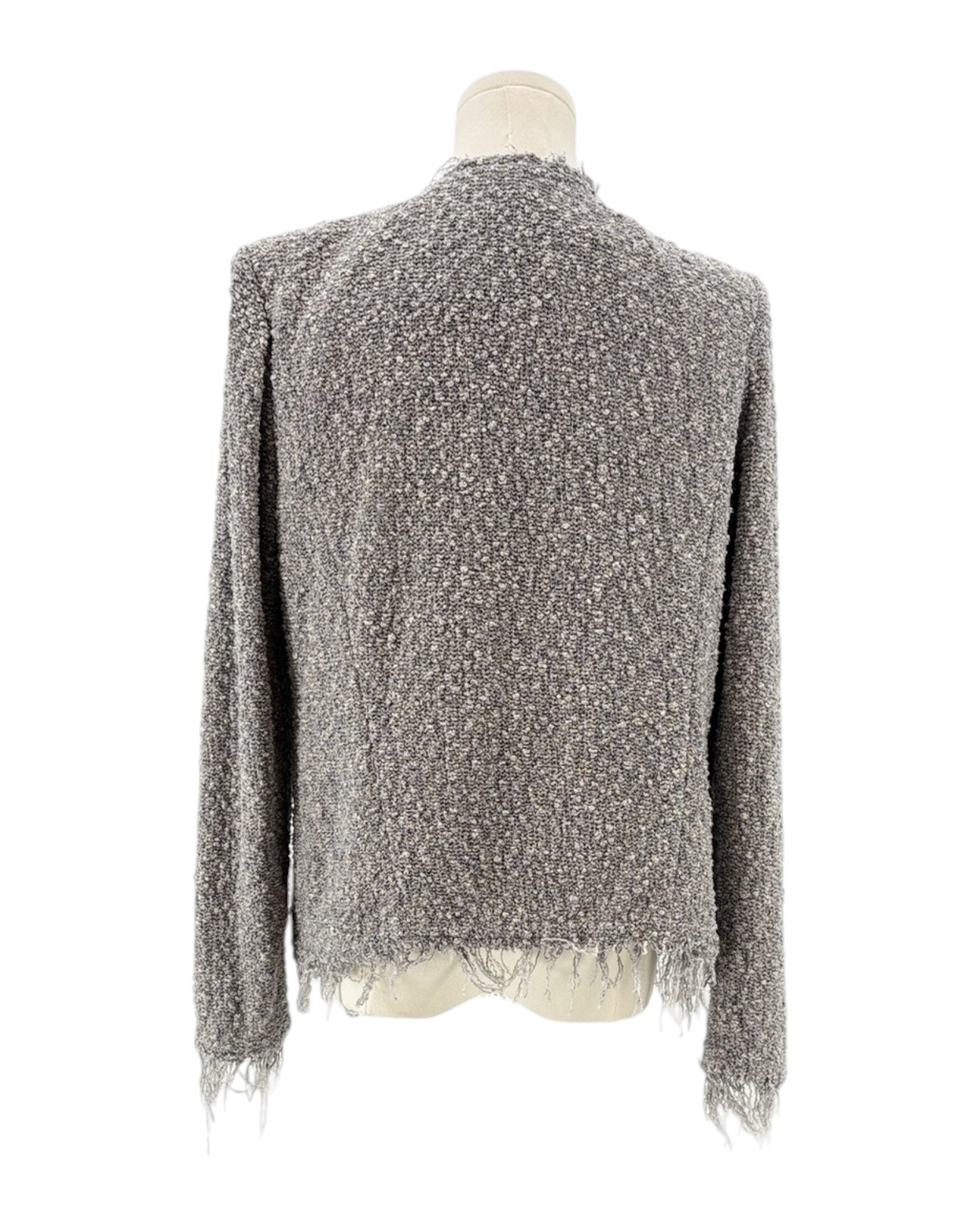 Gray textured sweater with fringe on a mannequin against a white background
