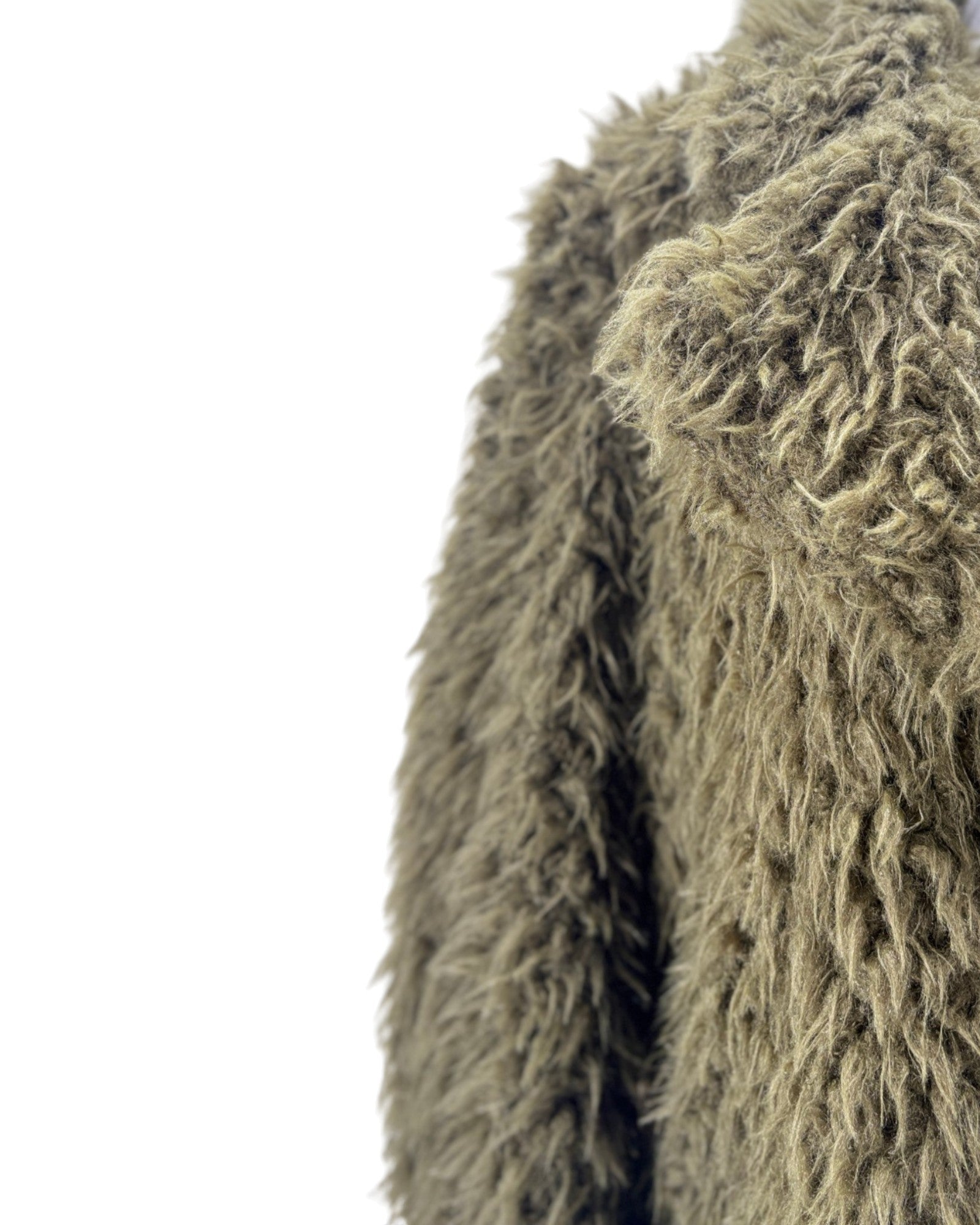Close-up of a textured green fabric on a white background