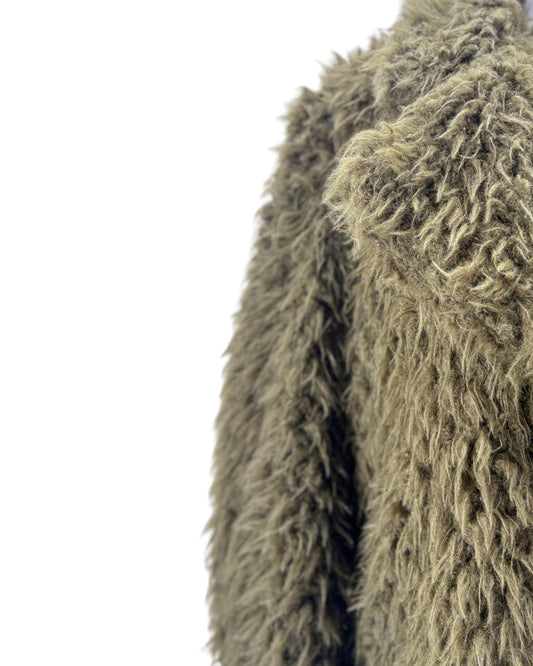 Close-up of a textured green fabric on a white background