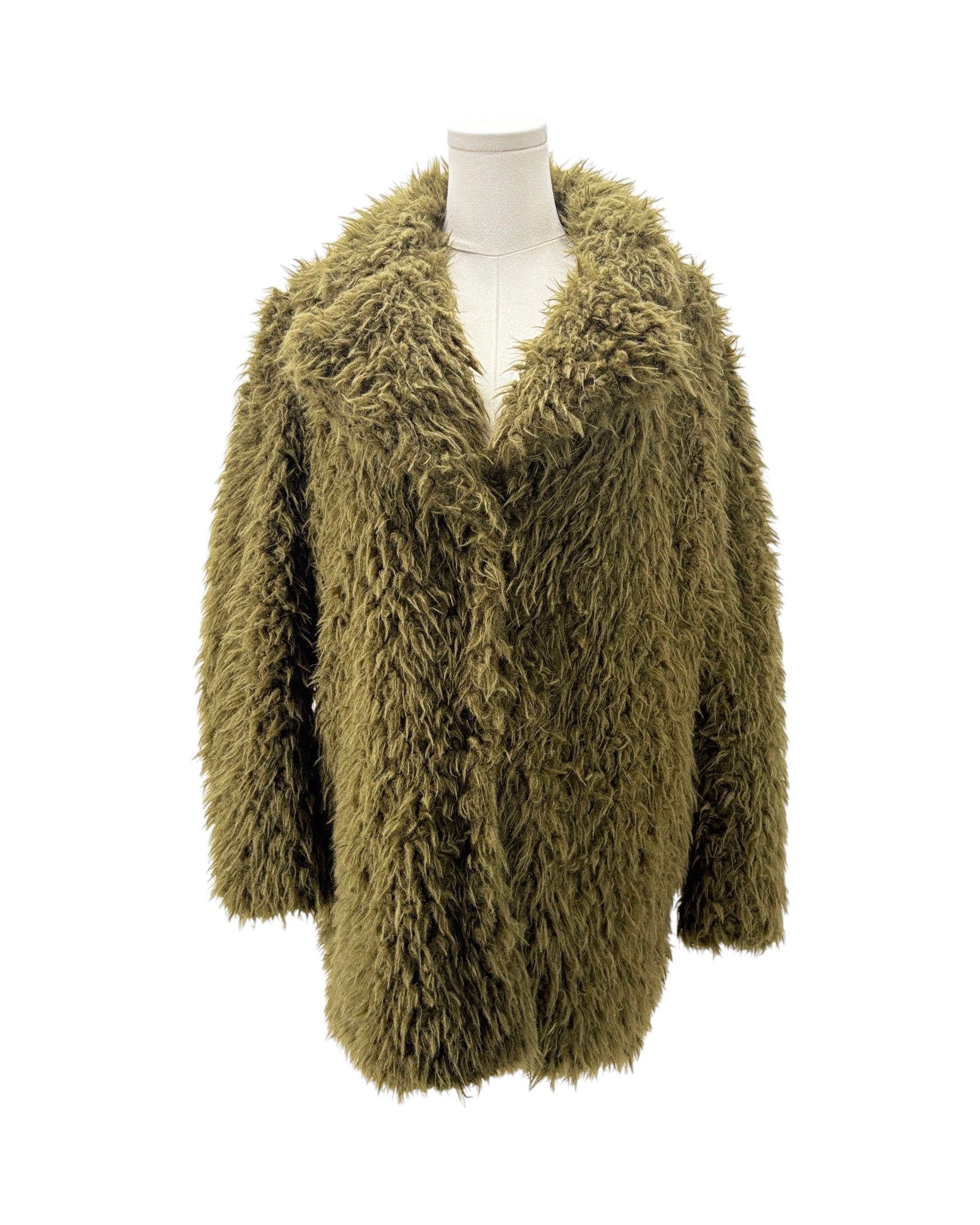 Green fluffy cardigan on a mannequin against a white background