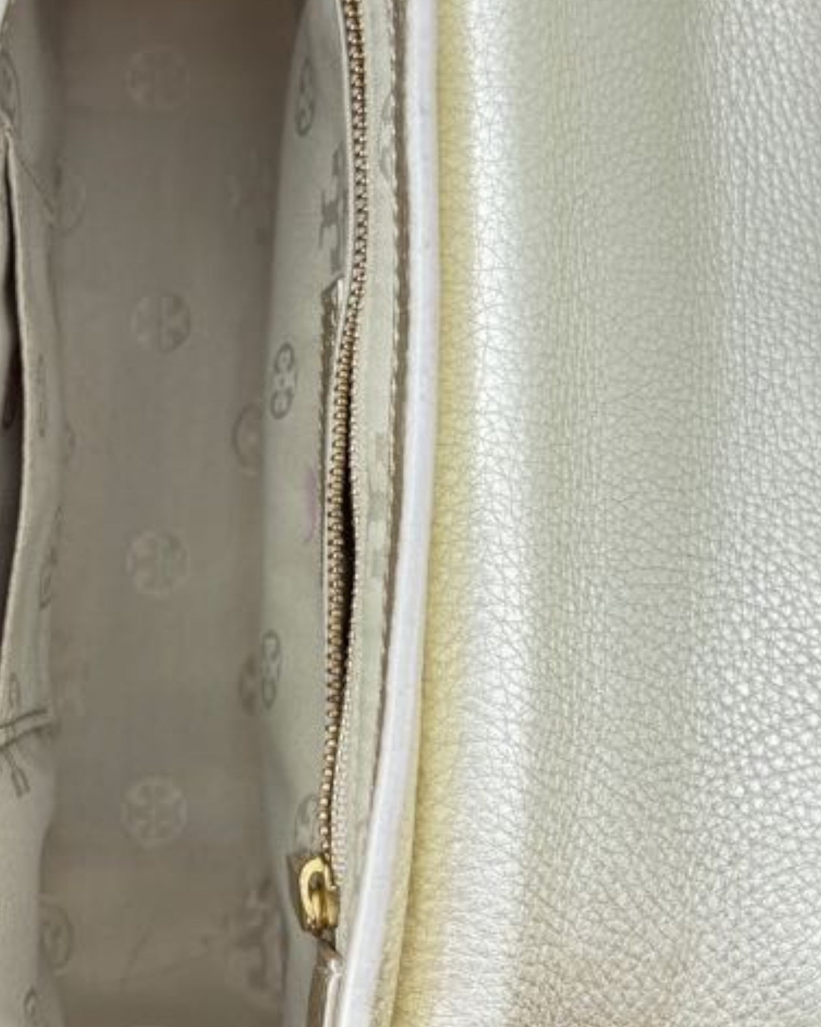 Close-up of a textured surface with a zipper and brand logo.