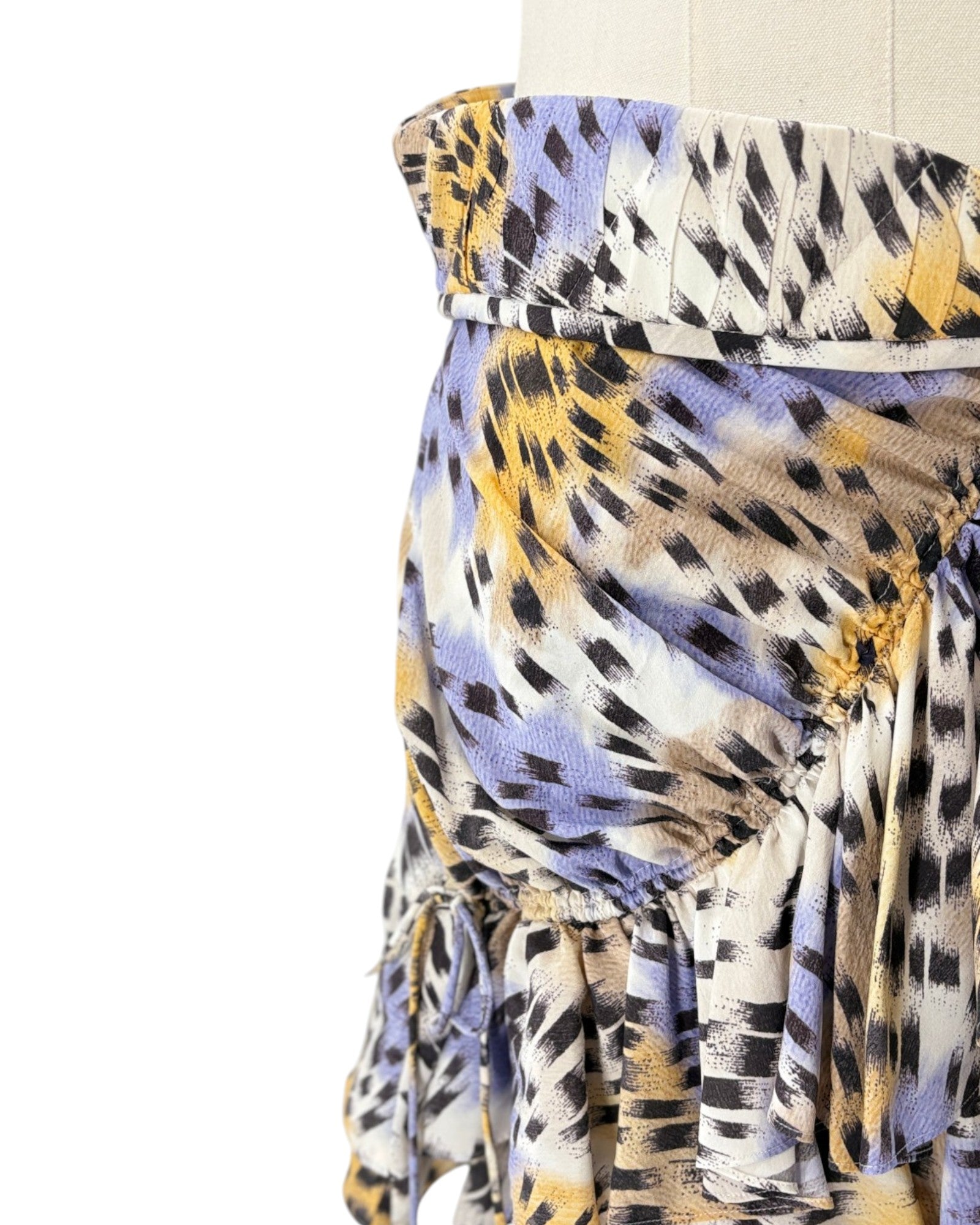 Colorful strapless top with abstract pattern on a white background