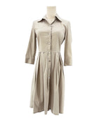 Beige dress on a mannequin against a white background
